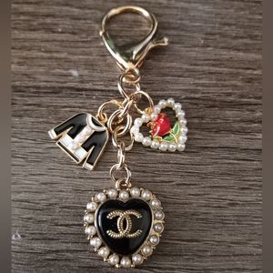 Authentic CHANEL black pearl heart button on an unbranded keychain